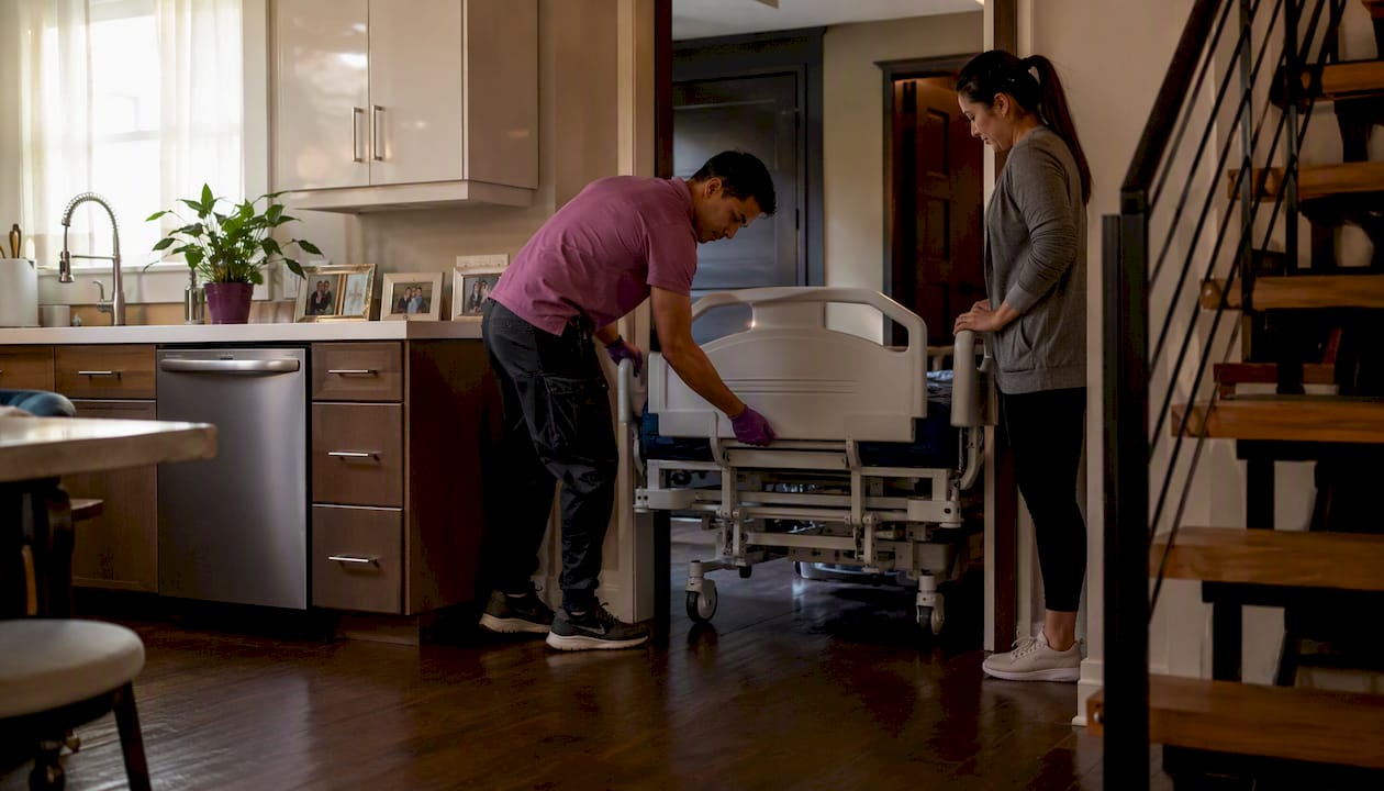 Hospital bed being delivered into home hallway