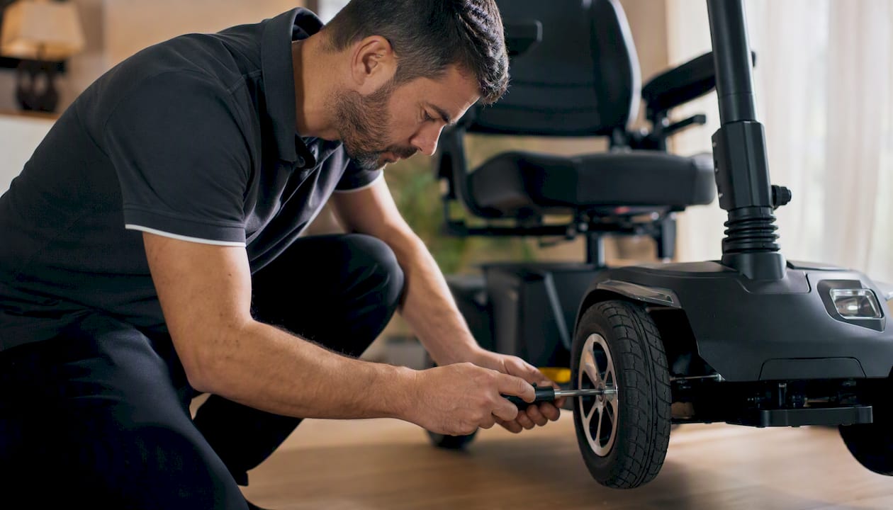 Technician inspecting scooter damage