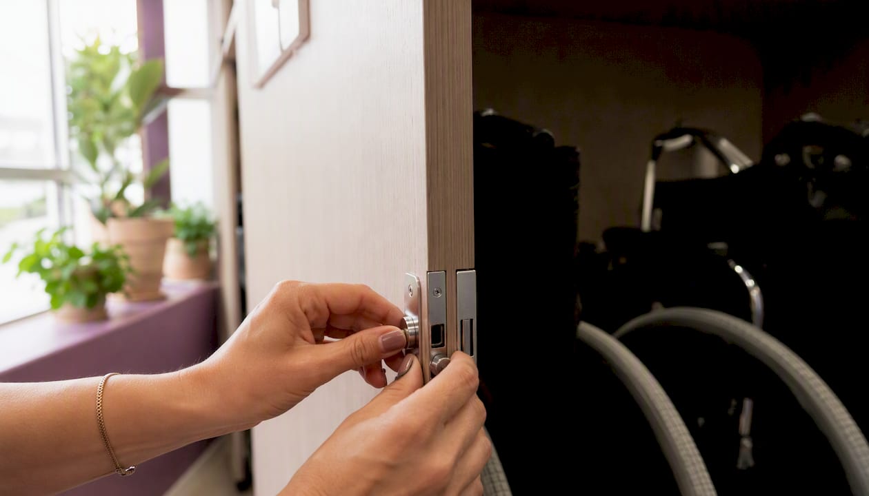 Hands opening cabinet with wheelchairs inside