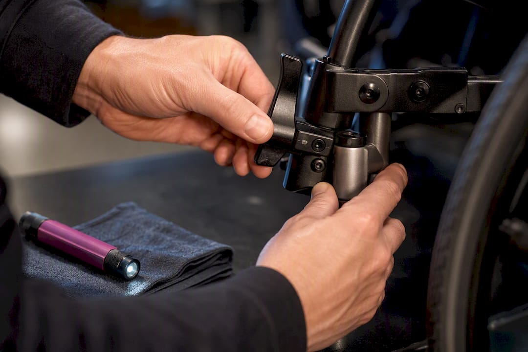 Technician inspecting wheelchair brake joint