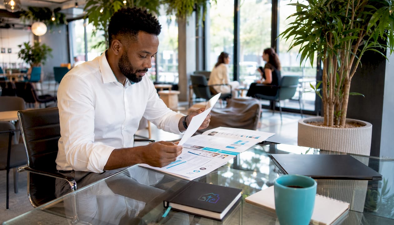 Property manager reviewing software alternatives at desk
