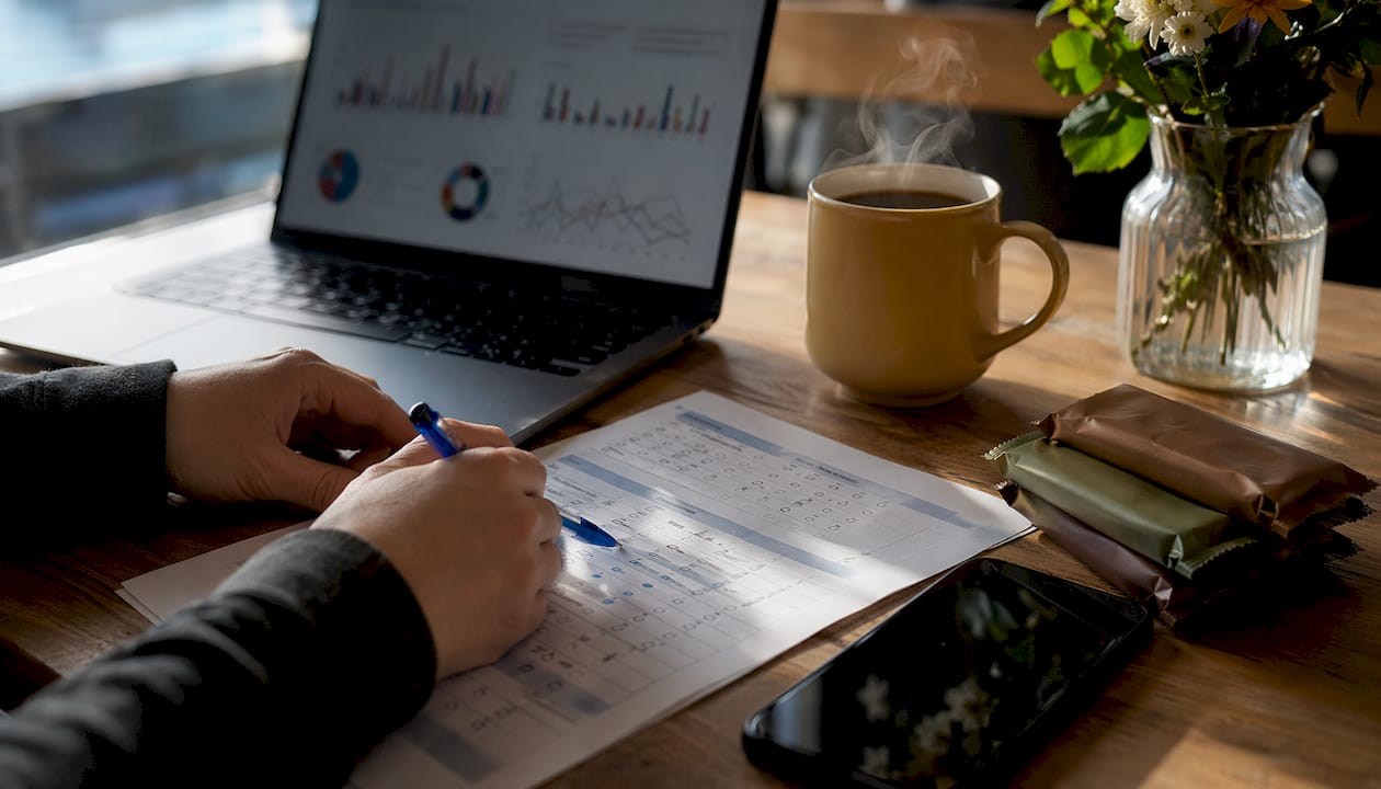 Hands reviewing market research survey papers