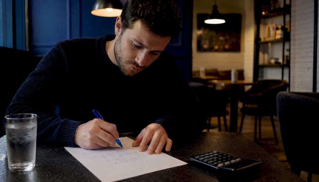 Trader sketching Kelly position sizing formula