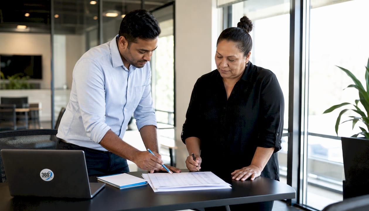 Supervisors reviewing cleaning checklist in office