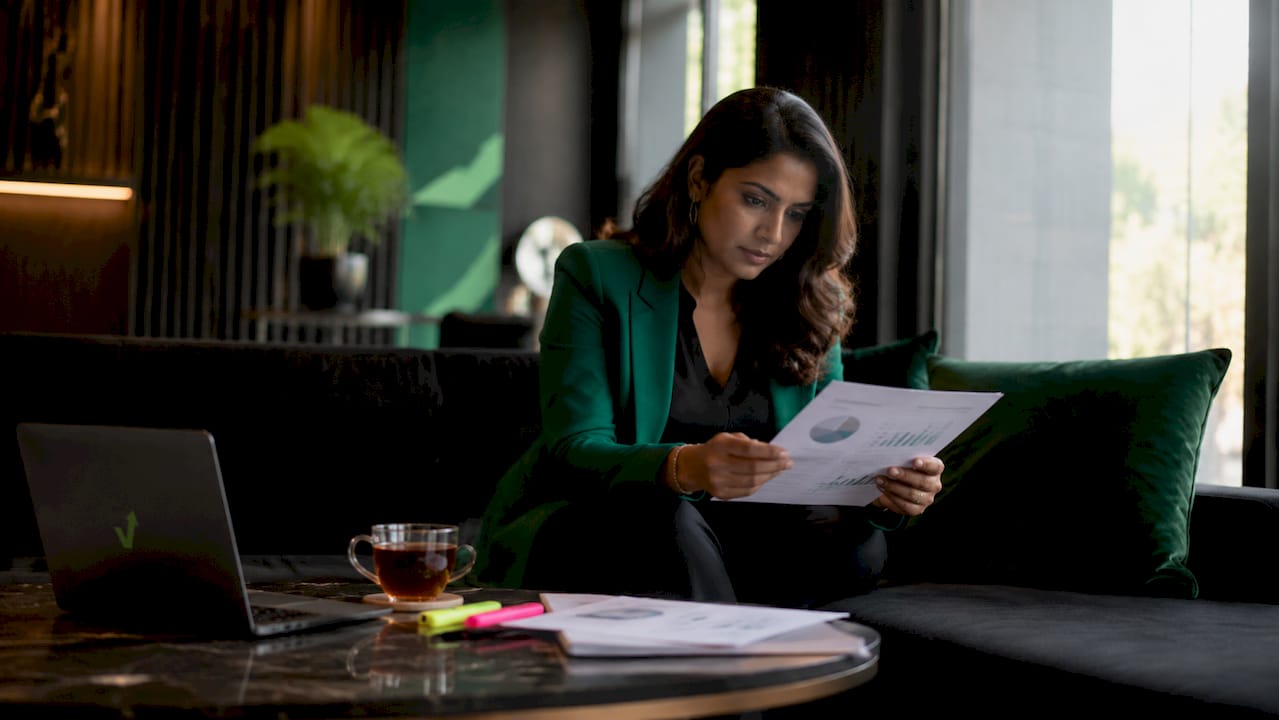 Businesswoman reviewing reputation repair report in office