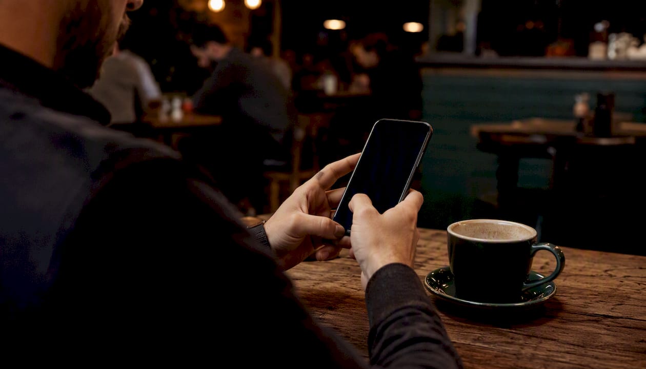 Hands typing review request SMS on smartphone