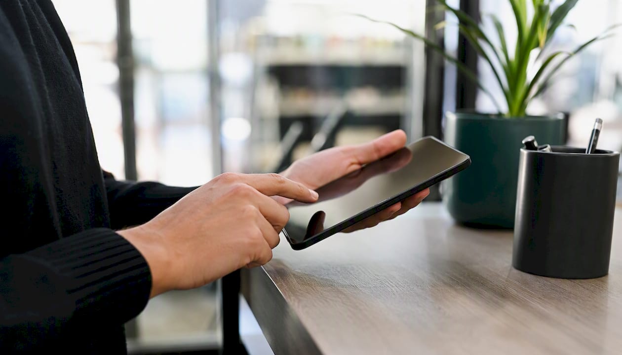Hands entering consent data on device