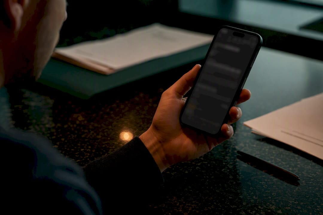 Hand scrutinizing phone for fake review signals