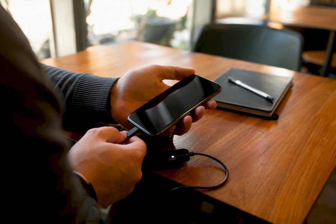 Hands preserving digital evidence on smartphone