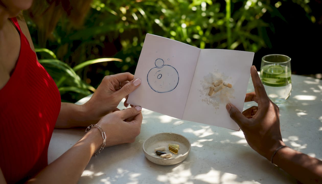 Hands holding skincare supplement ingredient pamphlet