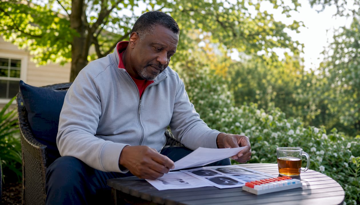 Man reviewing heart health documents at home