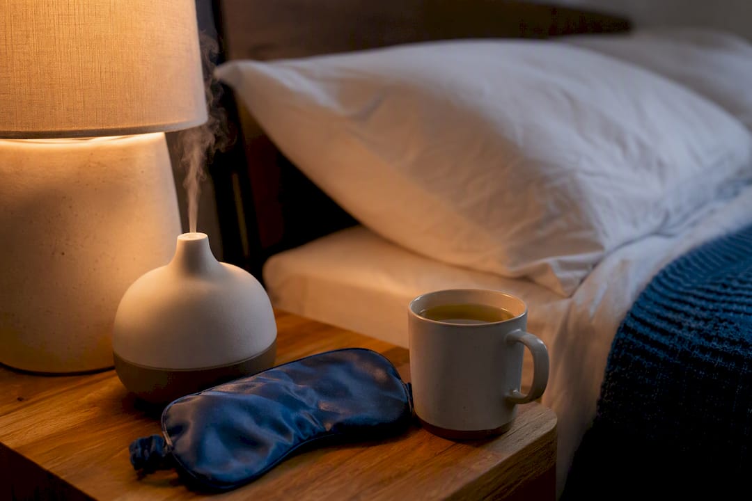 Diffuser and sleep mask on bedside table
