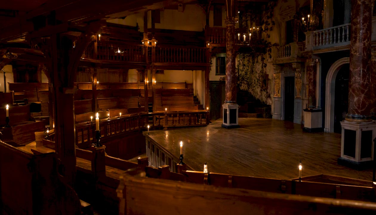 Candlelit interior of Elizabethan theater