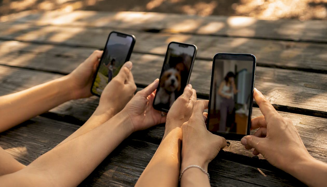 Hands holding phone displaying different selfie types