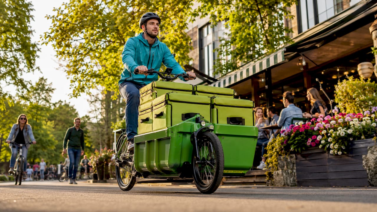 Fietscourier op een elektrische fiets in de stad