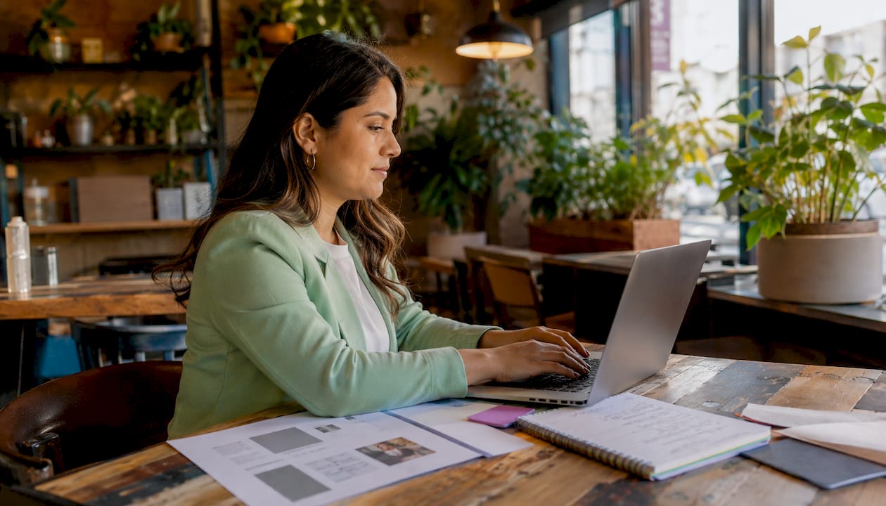 Hands typing website content in coworking space