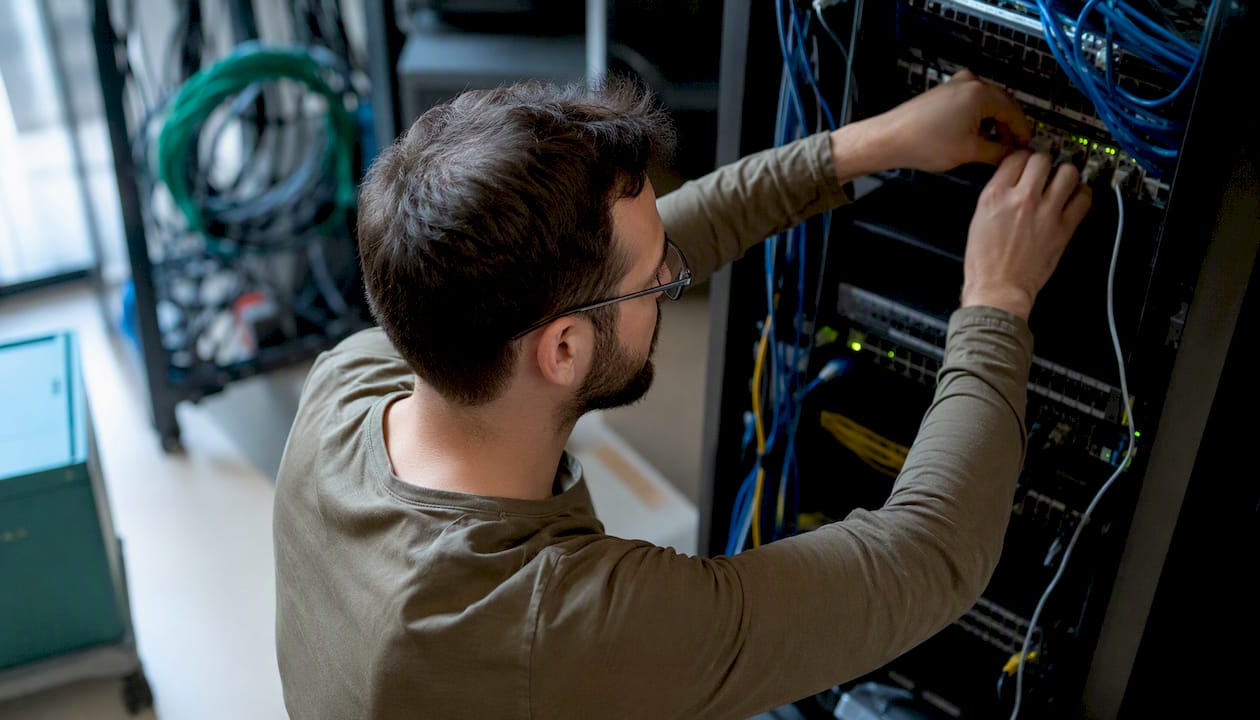 Technician connecting network cables