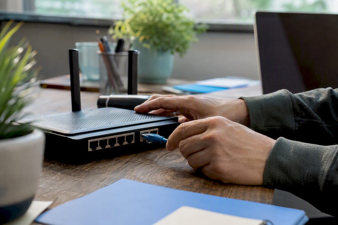 Hands connecting network cable in small business environment
