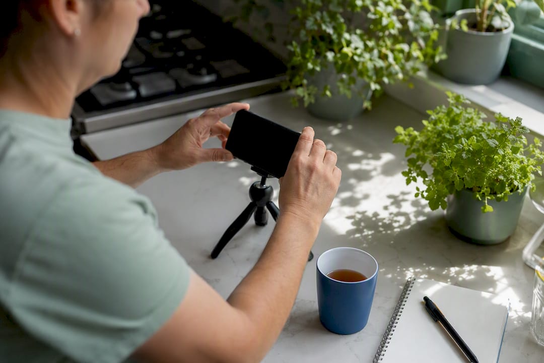 Hands preparing smartphone to film video content