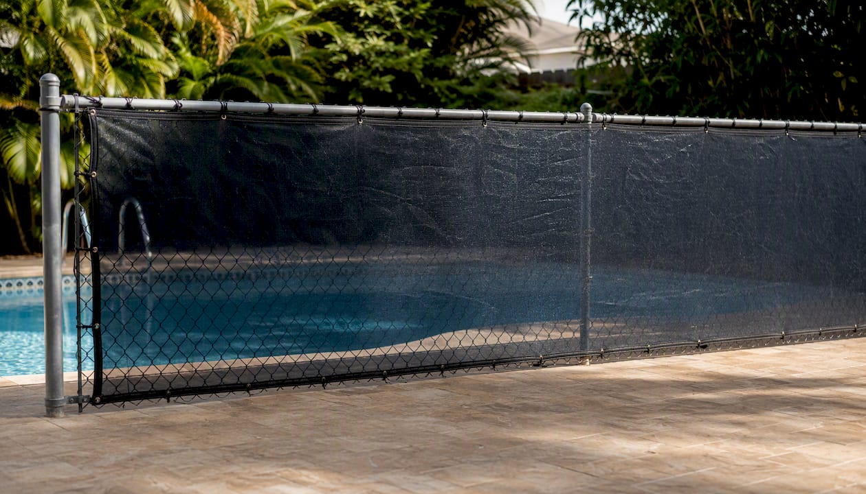 Vinyl windscreen attached to chain-link pool fence