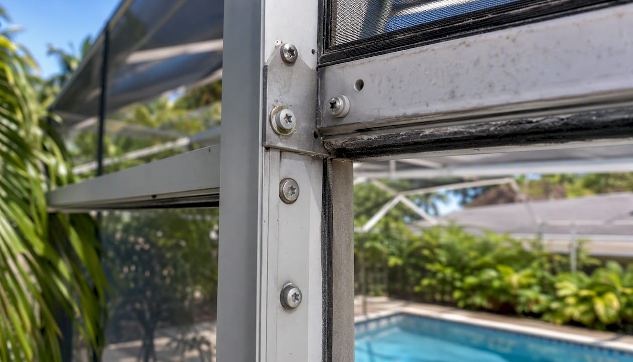 Pool cage frame with mixed metal fasteners close-up