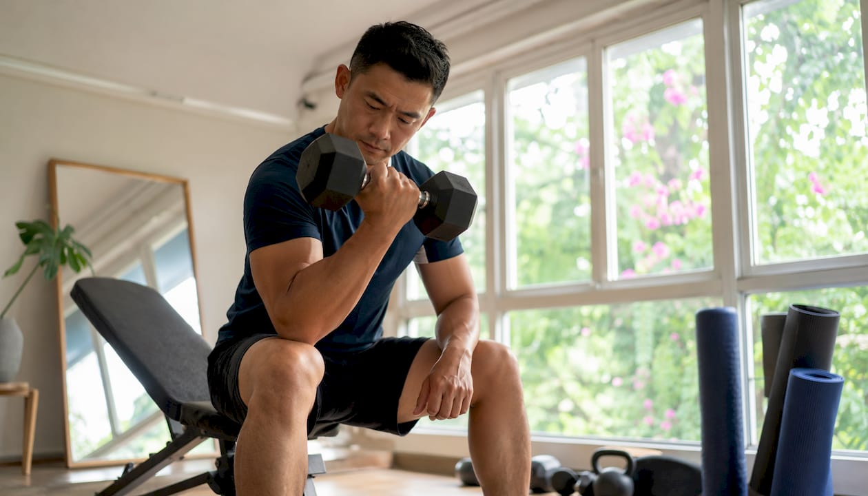 Man strength training in gym setting