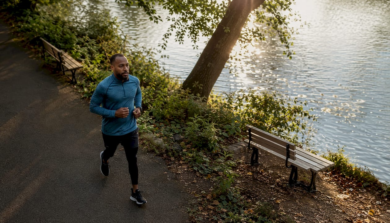 Man jogging mindfully in a park