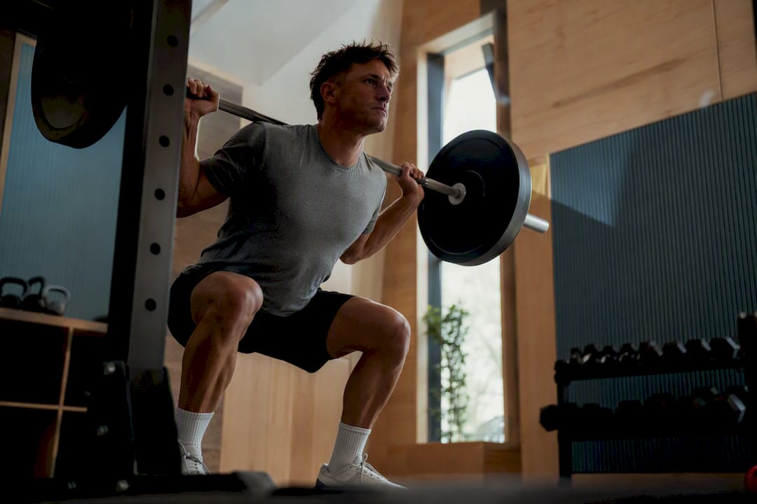 Athlete doing weighted squat in gym