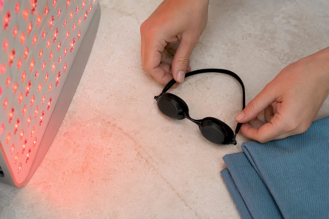 Protective goggles beside red light treatment equipment