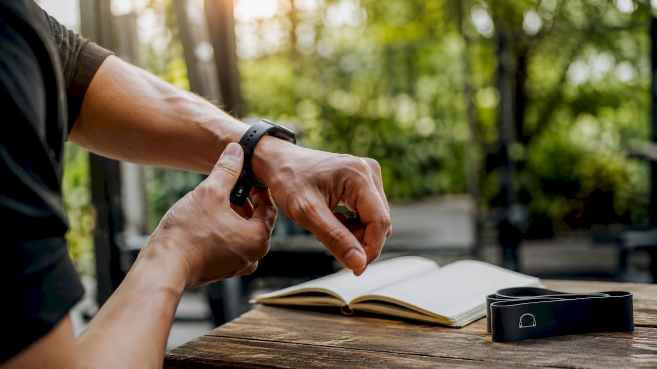 Close-up of hand adjusting wrist heart rate wearable