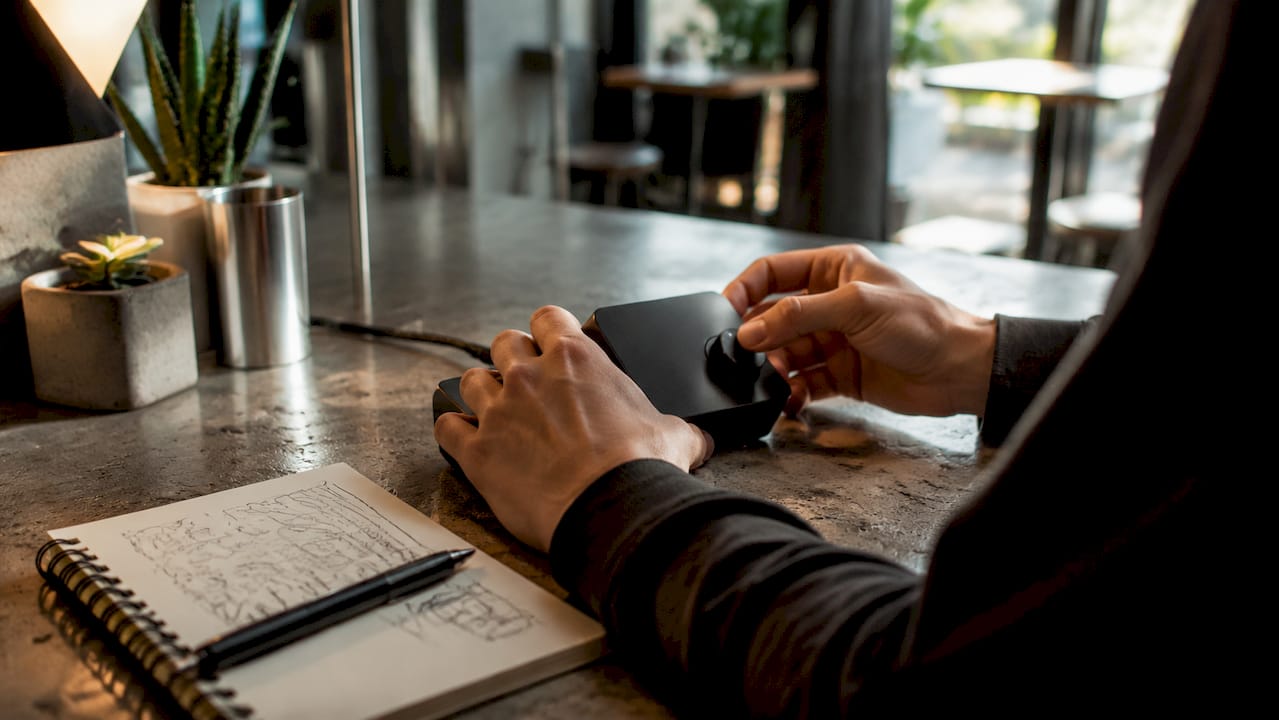 Hands adjusting music player for meditation session