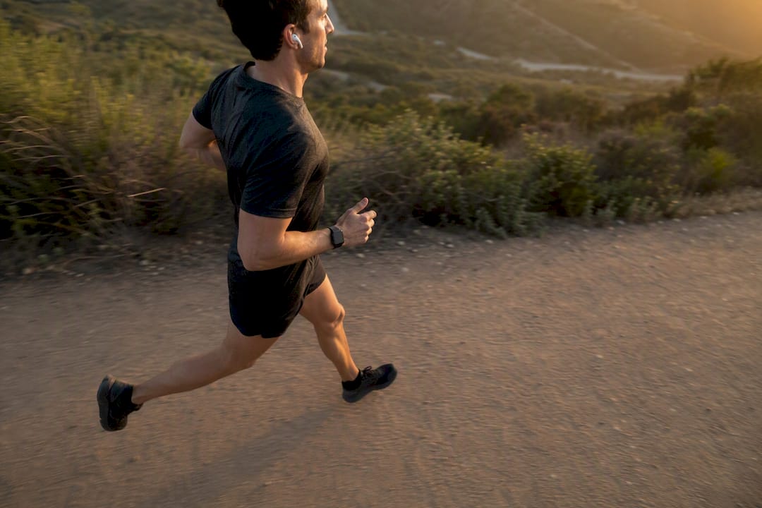 Runner syncing steps to music tempo