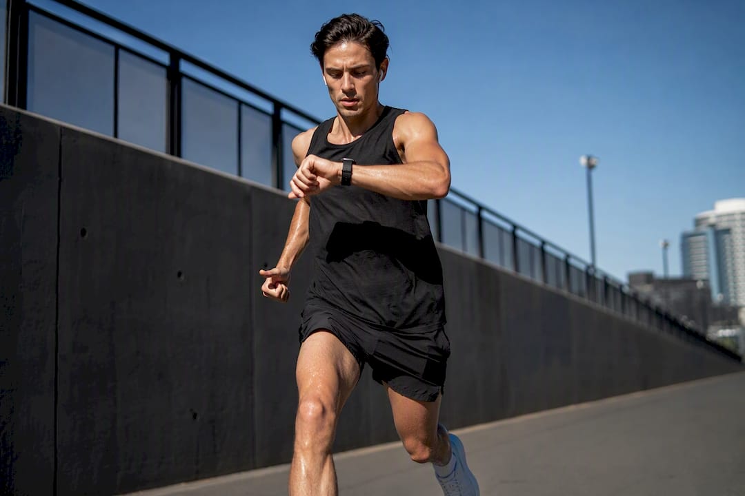 Runner checking smartwatch during interval run