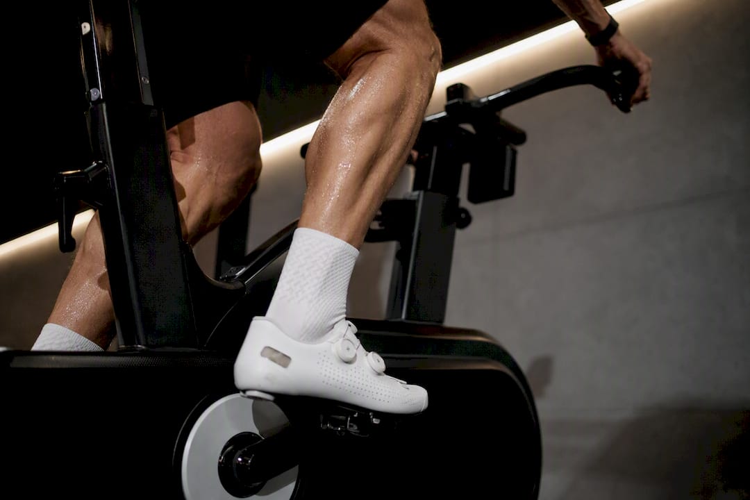 Close-up of cyclist legs pedaling indoors