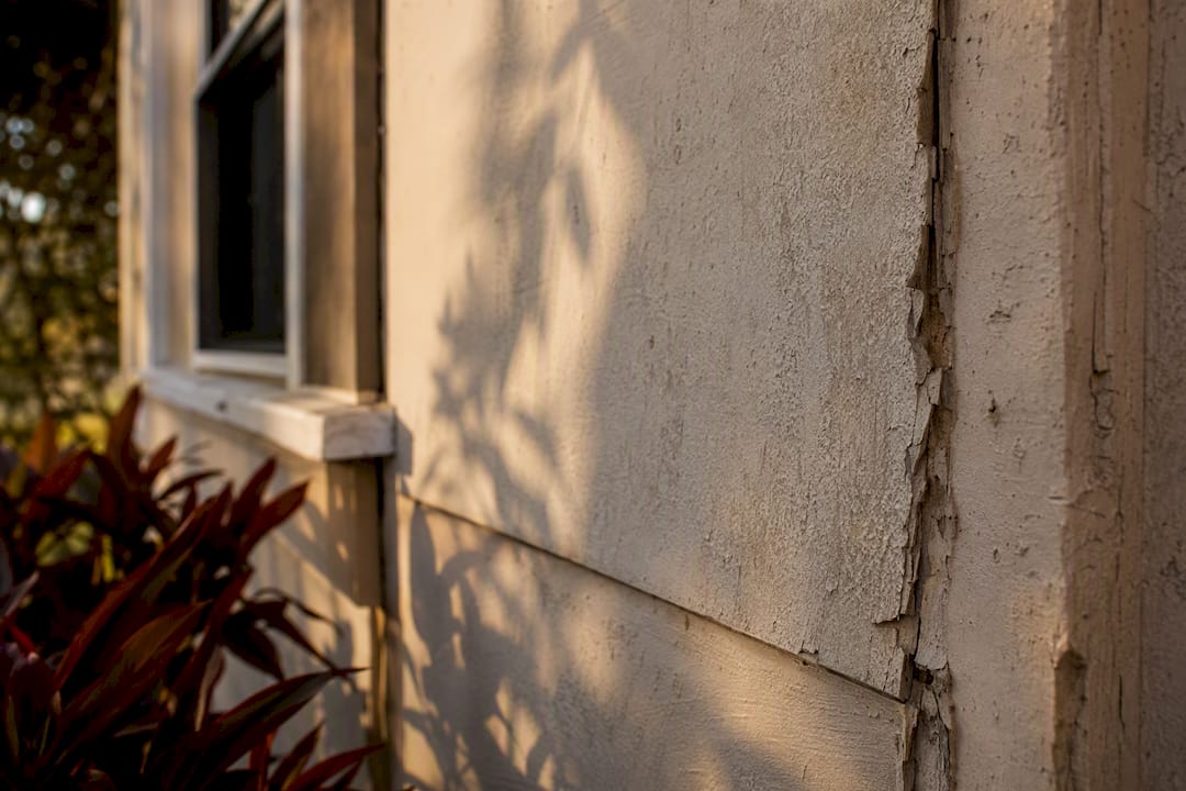 Sun-damaged chalking paint on Florida exterior wall