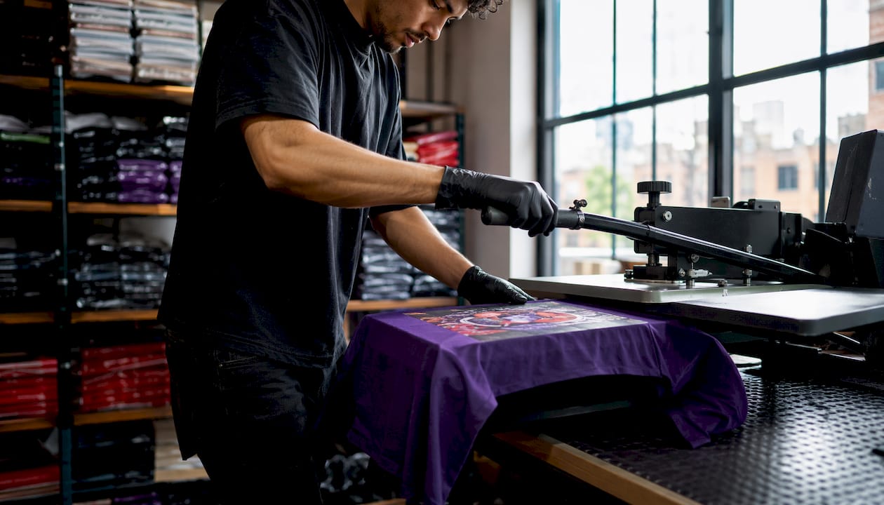 Heat press applying custom DTF transfer on t-shirt