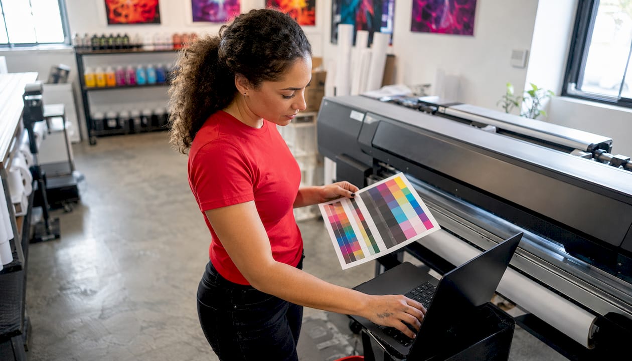 Technician adjusting color profiles for print