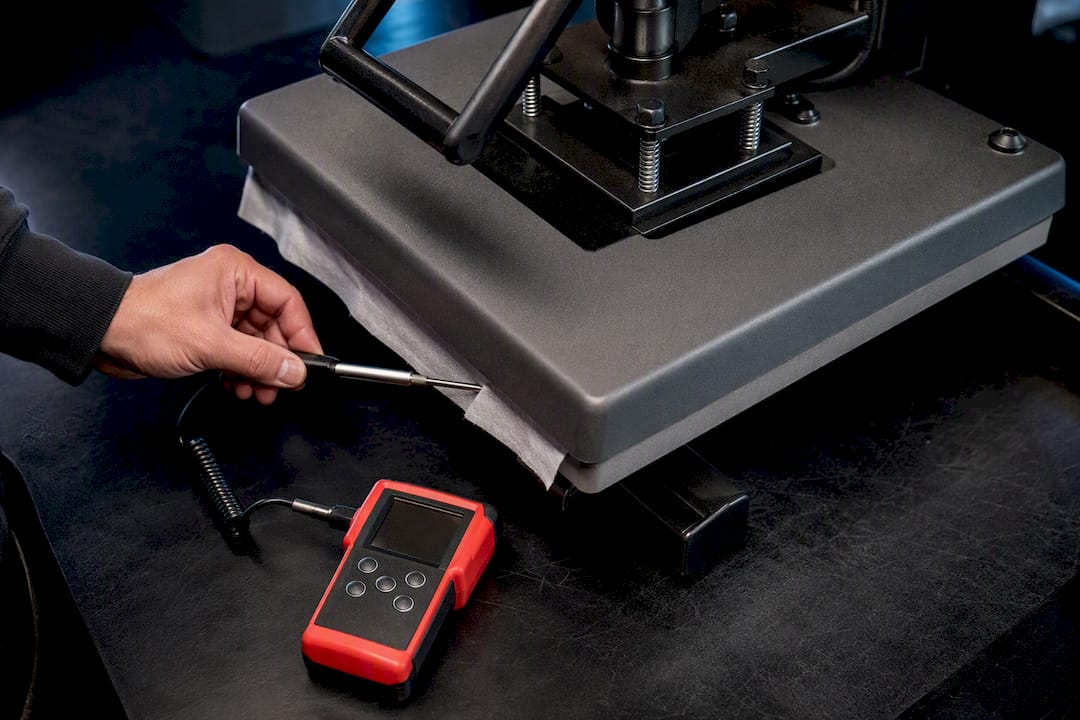 Technician calibrating heat press temperature
