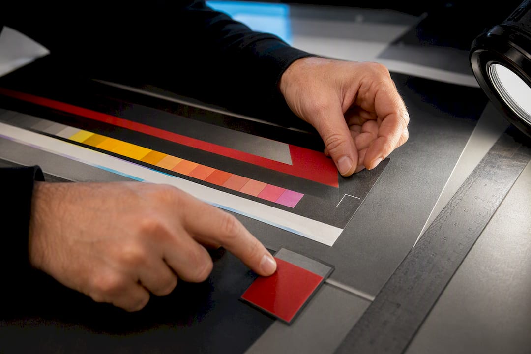 Technician checking proof colours and trim edge