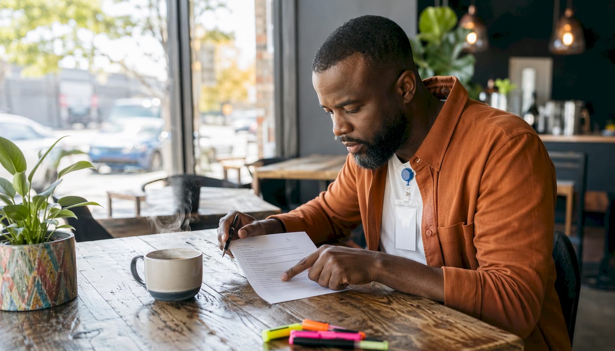 Mid-career nurse examining resume in clinic office