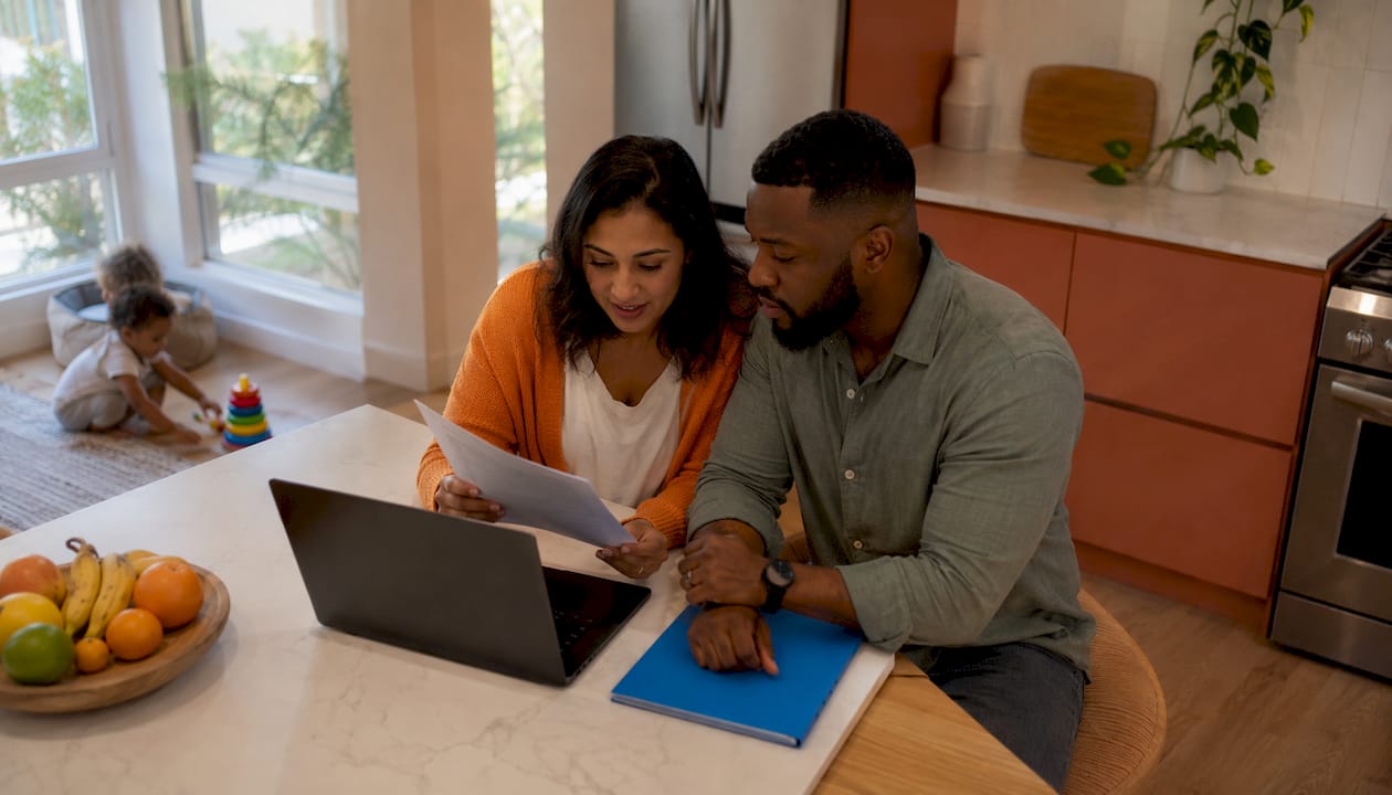 Parents reviewing medical documents at home