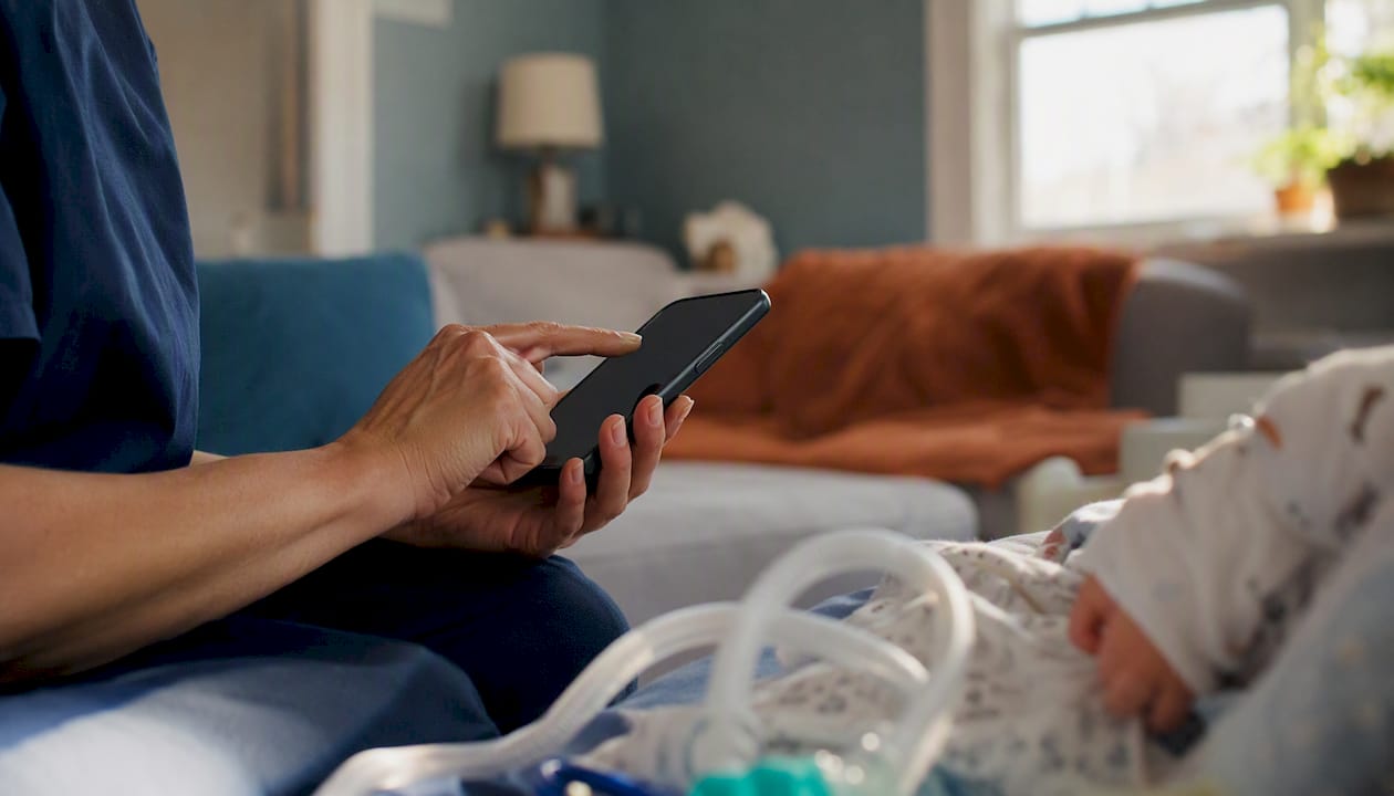 Caregiver tapping smartphone to check in visit