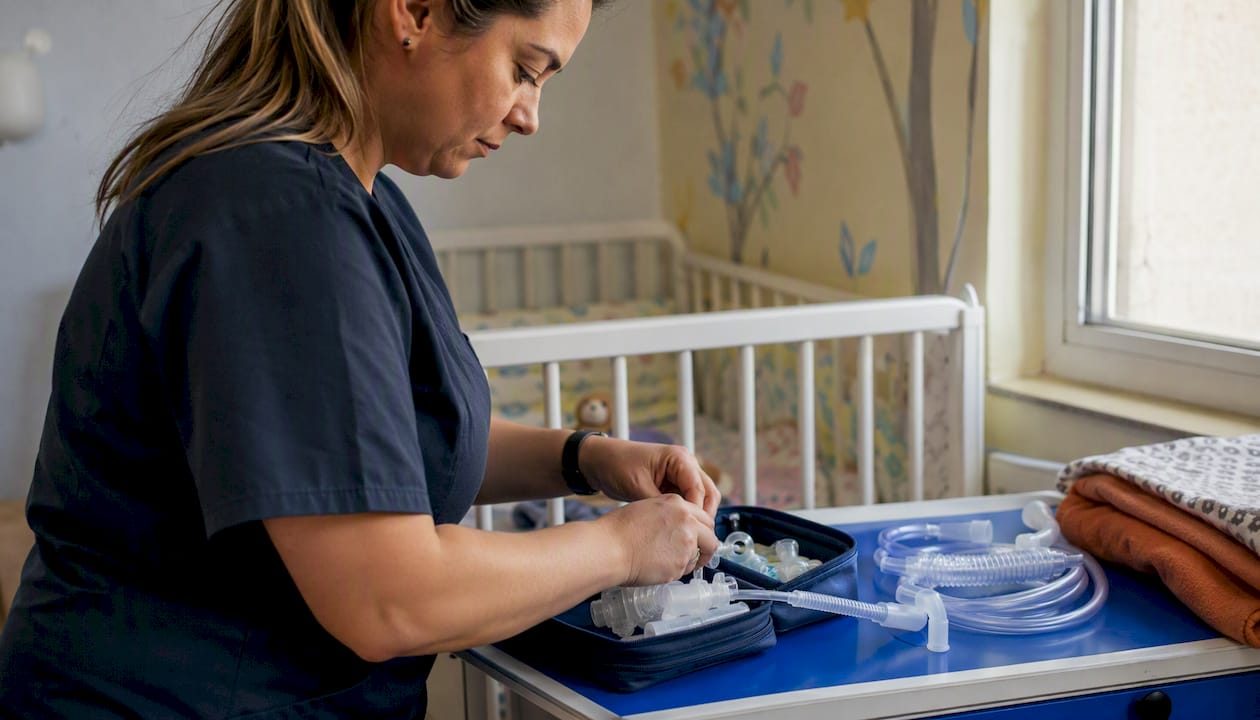 Pediatric nurse preparing in-home medical supplies