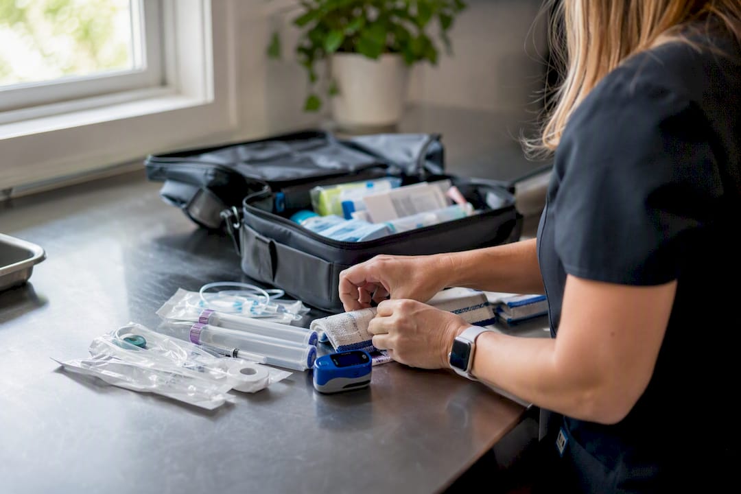 Hands preparing pediatric emergency home care kit