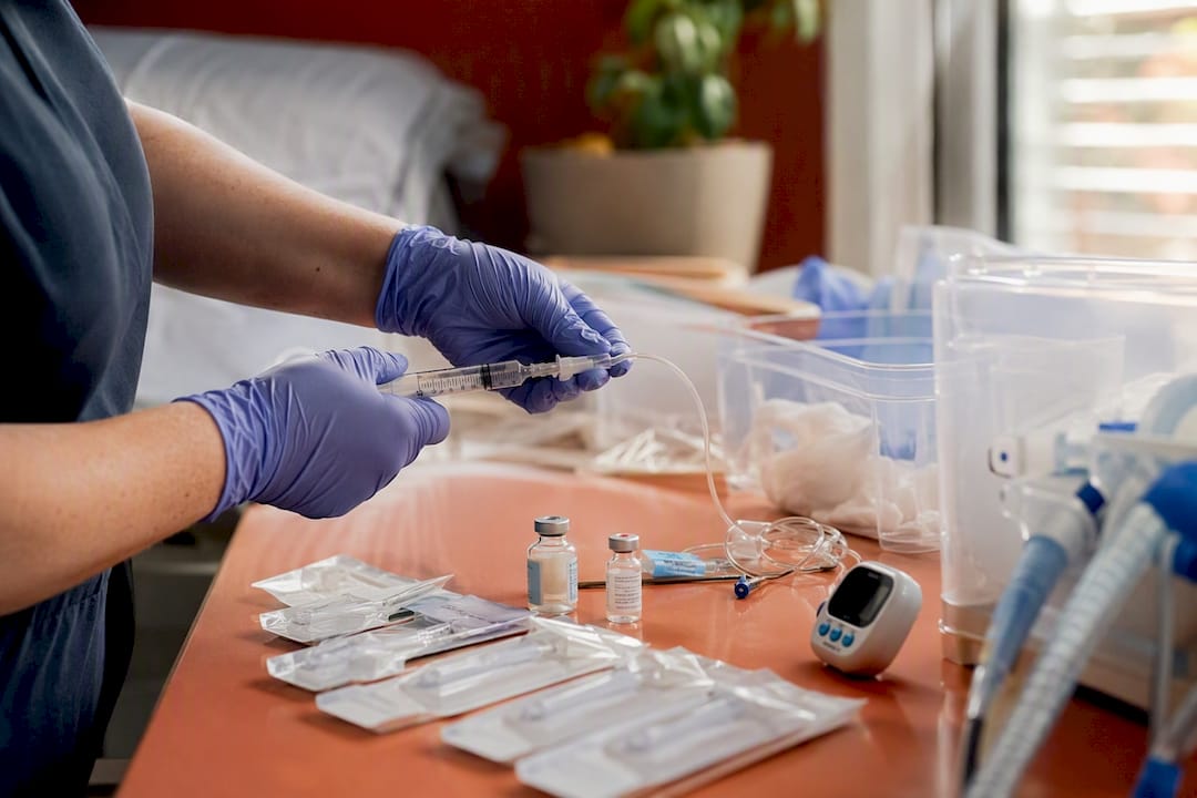 Hands preparing pediatric nursing supplies