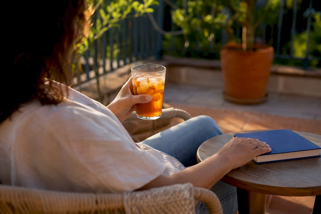 Parent relaxing with warm beverage at home