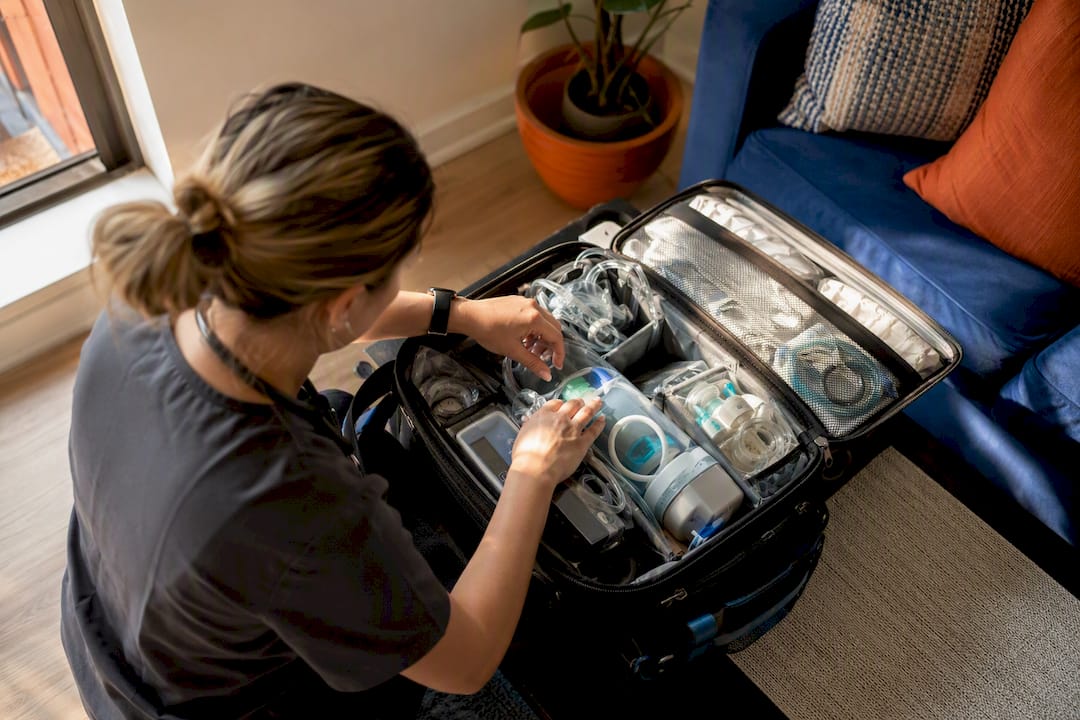 Nurse preparing pediatric care bag for home visit