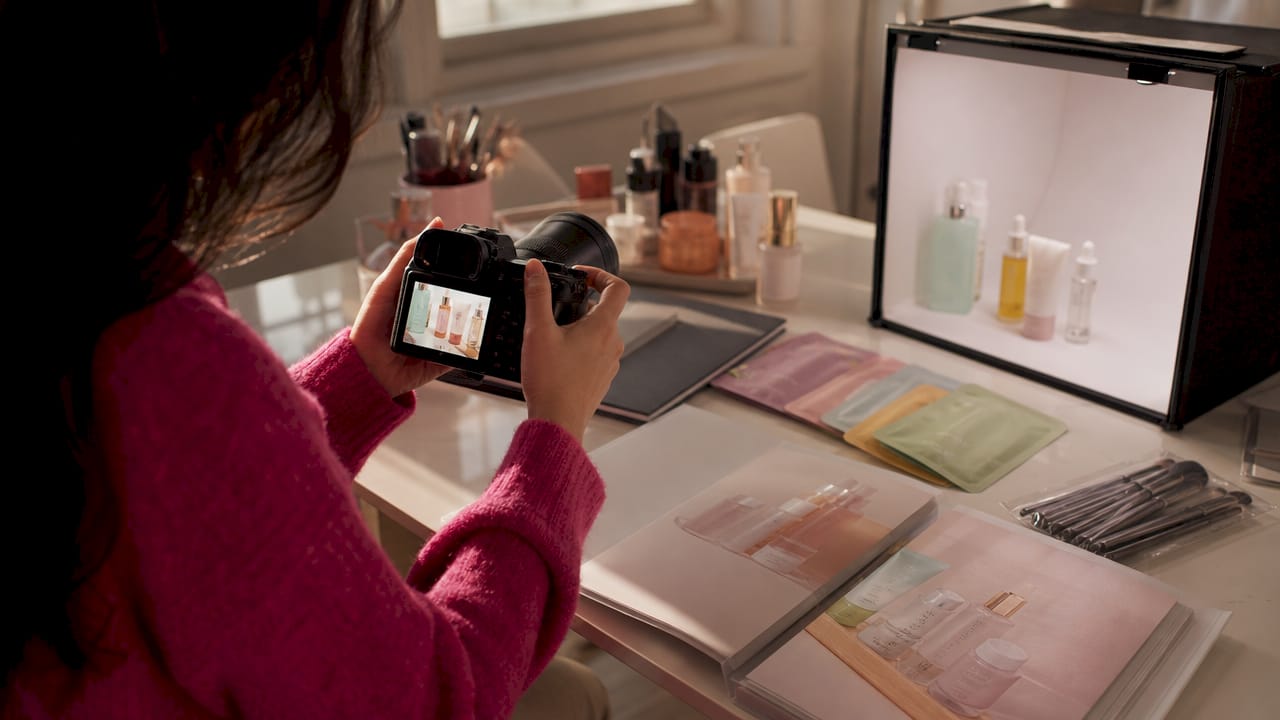 Hands reviewing K-beauty product photos on camera