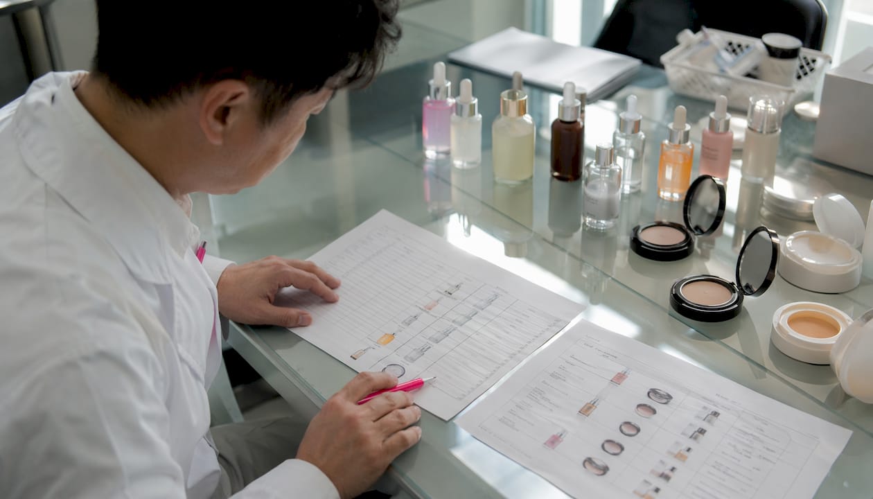 Factory manager reviewing skincare production checklist