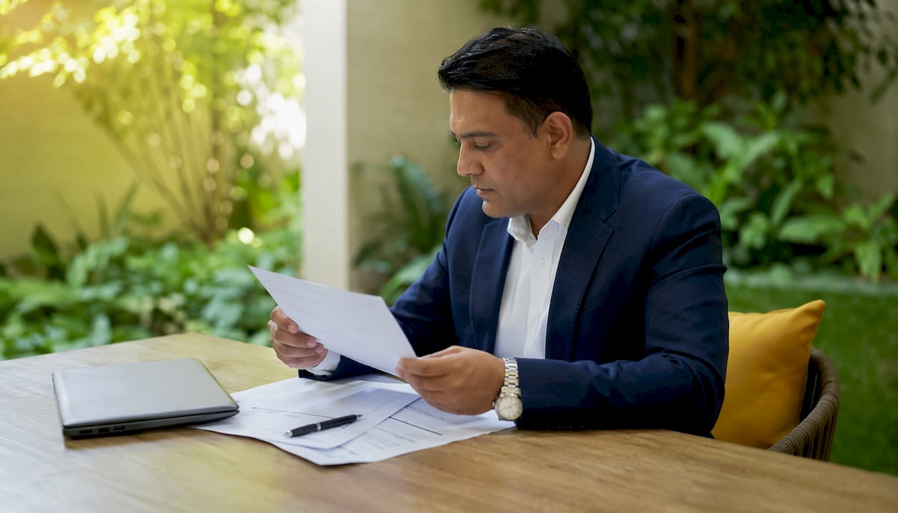 Hands examining audit exemption documents